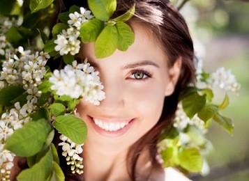 beautiful happy brunette woman in the park on a warm summer day