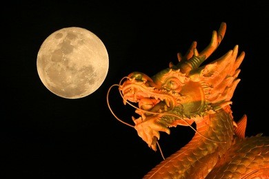 golden dragon with moon in sky background.