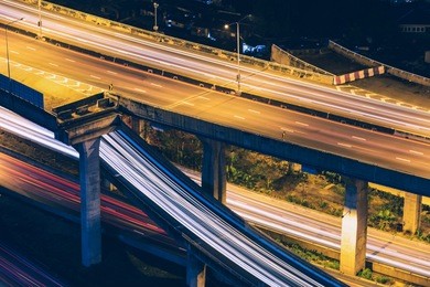 light trails on express highway at night, long exposure abstract urban background