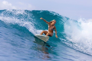 surfer girl on a wave,bali,indonesia