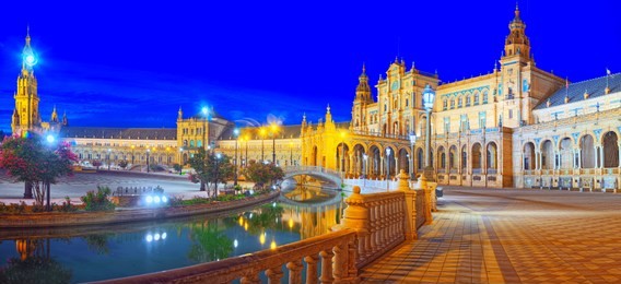 spain square (plaza de espana)is a square in the maria luisa park, in seville, spain, built in 1928 for the ibero-american exposition of 1929. nighttime.