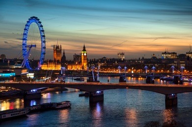 landscape image of the london skyline at night looking along the river thames