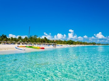 the beautiful beach of varadero in cuba with colorful boats and thatched umbrellas (image taken from the sea)