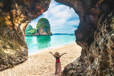 landscape of phra nang cave beach, traveler woman joy relaxing on sand beach, ao nang beach, krabi, travel popular place thailand, beautiful destination asia, summer holiday outdoor vacation trip