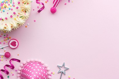 pink birthday party background with birthday cake and party hats