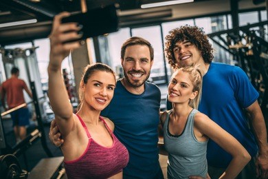 friends having fun at the gym. making a selfie photo.