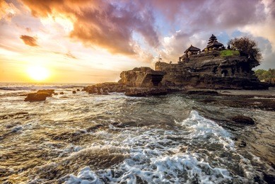 tanah lot water temple in bali during sunset. famous hindu temple main bali landmark. indonesia.