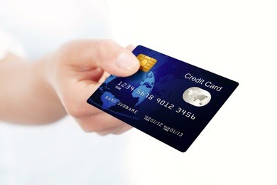 closeup of blue credit card holded by hand. focus on card