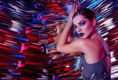beautiful young girl in the studio on a multicolored rainbow background - blue, blue, green, pink. 