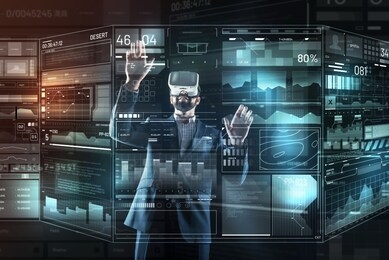 unforgettable experience. attentive interested progressive programmer feeling excited and putting his hands up while looking at the transparent screen though virtual reality glasses