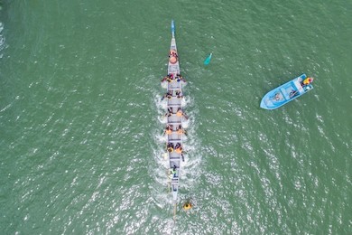 aerial view of a group of dragon boat paddler practice at likas bay sabah malaysia. dragon boat competition is an annual event in sabah malaysia.
