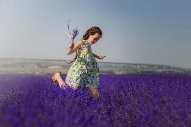 girl jumping in lavender