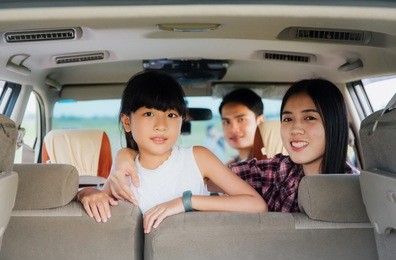 asian family travel in car .happy family sitting in car smiling.car insurance concept