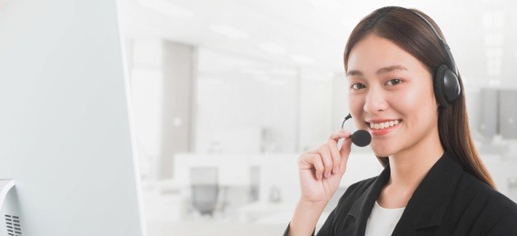 portrait of asian beautiful smiling woman customer support phone operator in office space background and copy space.concept call center job service.