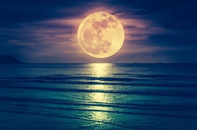 super moon. colorful sky with cloud and bright full moon over seascape in the evening. serenity nature background, outdoor at nighttime. cross process. the moon taken with my own camera.