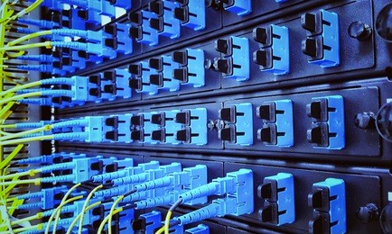 close up fiber optic in server room , network cables installed in the rack
