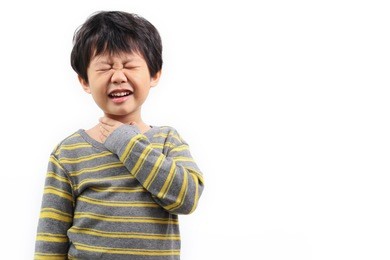little asian boy with sore throat touching her neck, feeling pain in her throat.