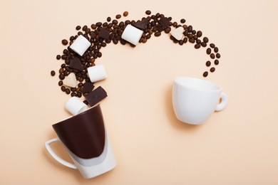 two cups with coffee beans on light background