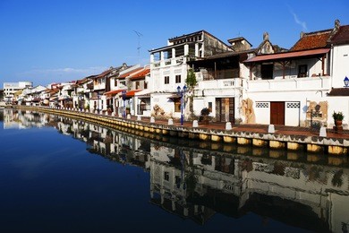 house near river under blue sky in malacca  malaysia