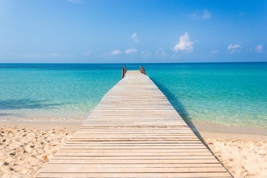 wooden bridge on the tropical beach and blue sky summer background