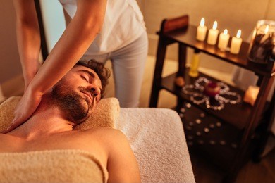 close up shot of a young man enjoying a head massage at a spa