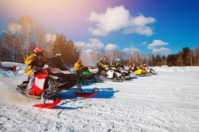 snowmobile races start in snow. concept winter sports, racers.
