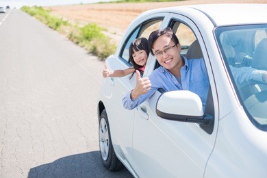 man with daughter drive car in furano