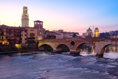 image of verona. pietra bridge on adige river after sunset, verona, italy.