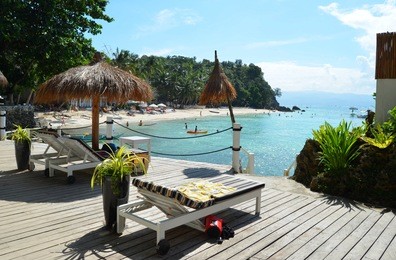 chaise longue and umbrella from straw overlooking the beach, azure sea, palm trees, full relaxation, boracay, diniwid beach, philippines