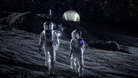 following shot of two astronauts in space suits walk on the alien planet looking at the sky. in the background base with geodesic dome. other worlds colonization and space travel concept.
