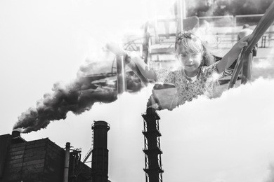 mining enterprise with smoke stacks. dirty smoke on the sky, ecology problems. the concept is pollution of the environment. children breathe dirty smoke produced by an industrial enterprise.