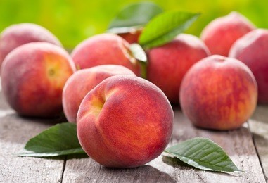 fresh peaches on wooden table