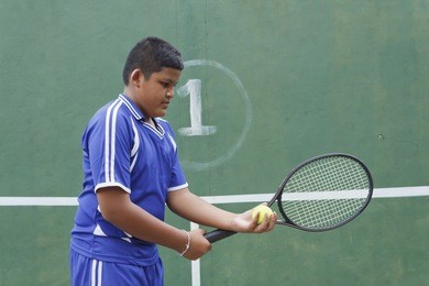 thai boy tennis player learning how to preparing to play tennis