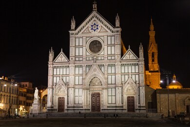 view of the basilica di santa croce by night in florence. there is the tomb of gallileo in the church.