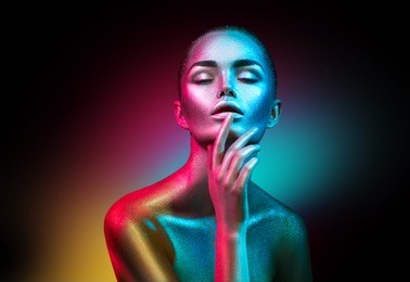 high fashion model woman in colorful bright sparkles and neon lights posing in studio, portrait of beautiful sexy girl, trendy glowing make-up. art design colorful make up. glitter vivid makeup