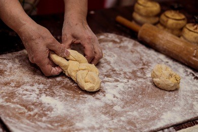 female hands making dough for pizza. making bread. cooking process concept