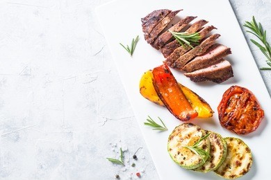 barbecue dish. beef steak and grilled vegetables top view.