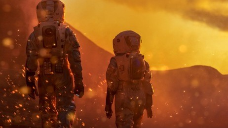 two astronauts wearing space suits exploring high temperature venus/ red planet during fire storm/ sunset. space travel and solar system colonization concept.