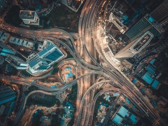 aerial view above of busy highway intersection road junctions at morning. the image contain soft focus, grain and noise.