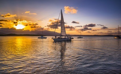 afternoon setting sun coral sea port douglas sailboat reflections daintree rainforest blue sky calm sea