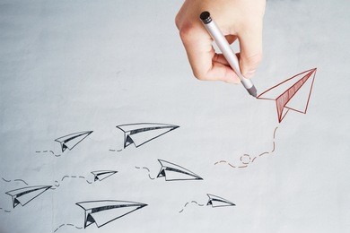 hand drawnwing  paper planes on concrete wall. leadership and startup concept 