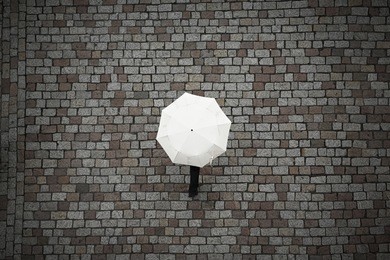 man with white umbrella in rain.