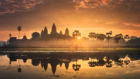 sunrise view of popular tourist attraction ancient temple complex angkor wat with reflected in lake siem reap, cambodia