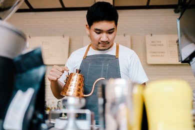 asian barista brewing coffee, method pour over, drip coffee. at coffeeshop.
