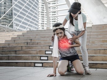 sport women is clutching her chest, acute pain possible heart attack.