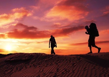 men in sand desert