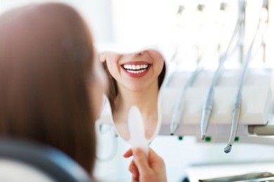 woman having teeth examined at dentists