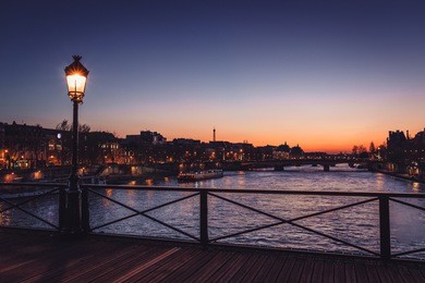 view of the seine river from the pont des art at the blue hour