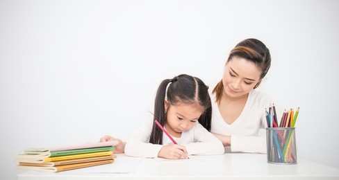 portrait of mother and daughter learning to write, mother teaching little girl homework isolated on white background, education study home school mother'??s day concept banner