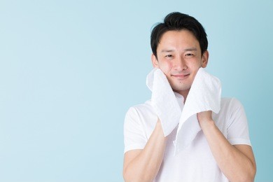portrait of young asian man isolated on blue background
